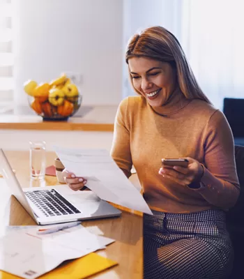 young couple reviewing finances on phone