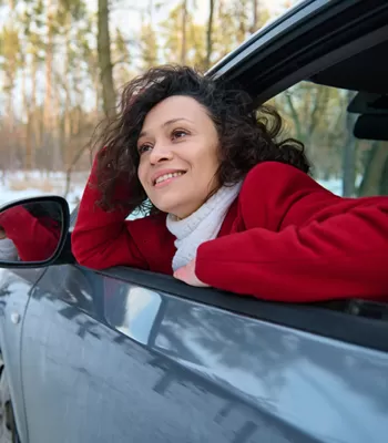 young woman sitting in car in winter season