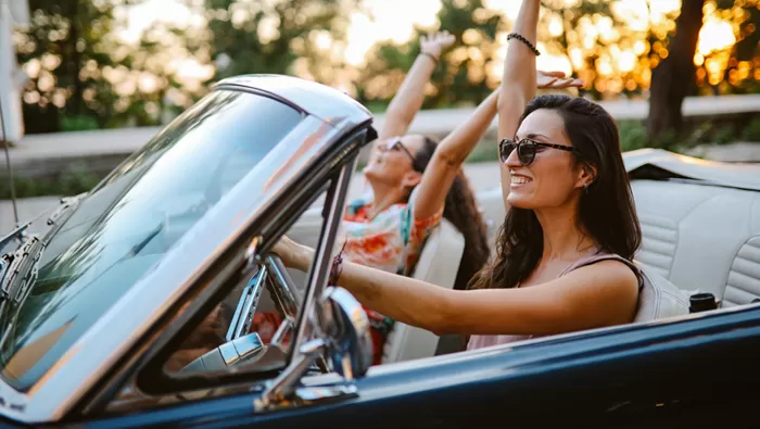 friends driving in classic car