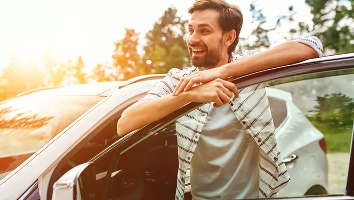 man standing outside car