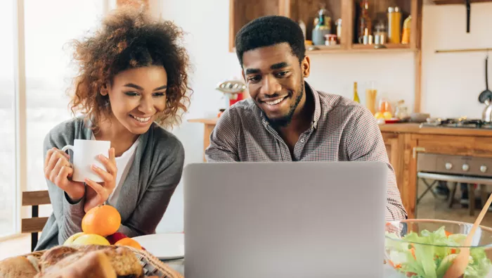 couple using computer reviewing finances